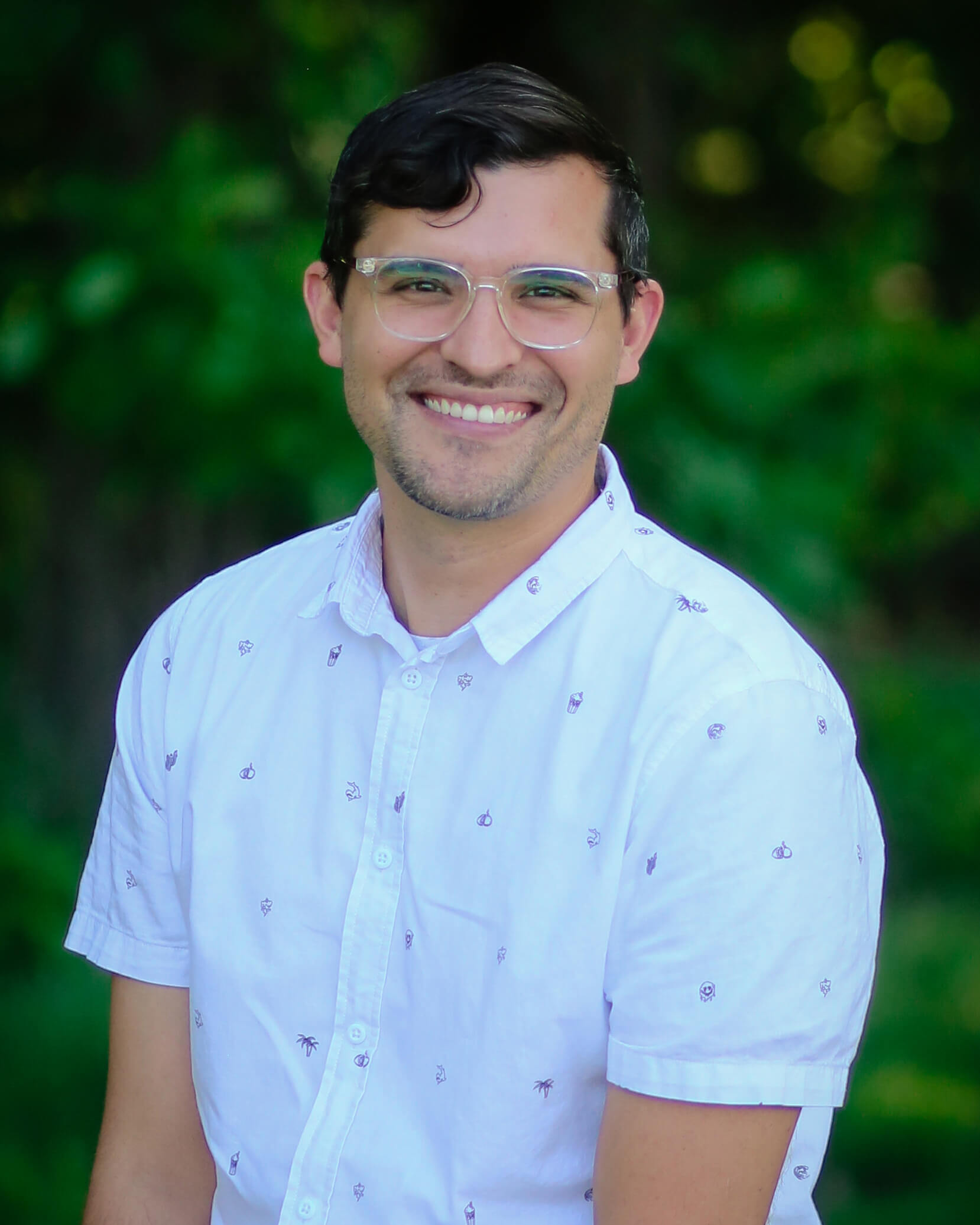 Brian Wilde, smiling, wearing a white short-sleeve button down shirt